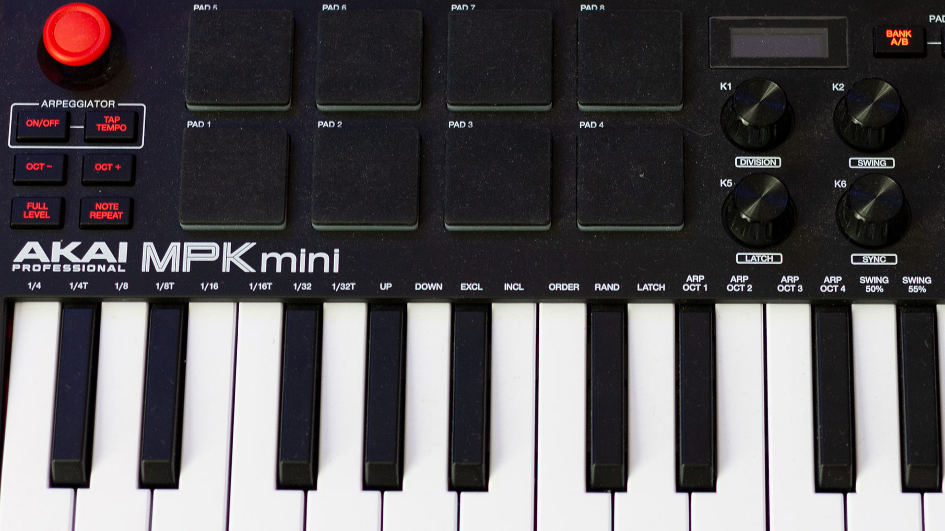 A closeup photo from above showing keys and pads of the AKAI MPK Mini MK3 Twenty-five key MIDI controller.