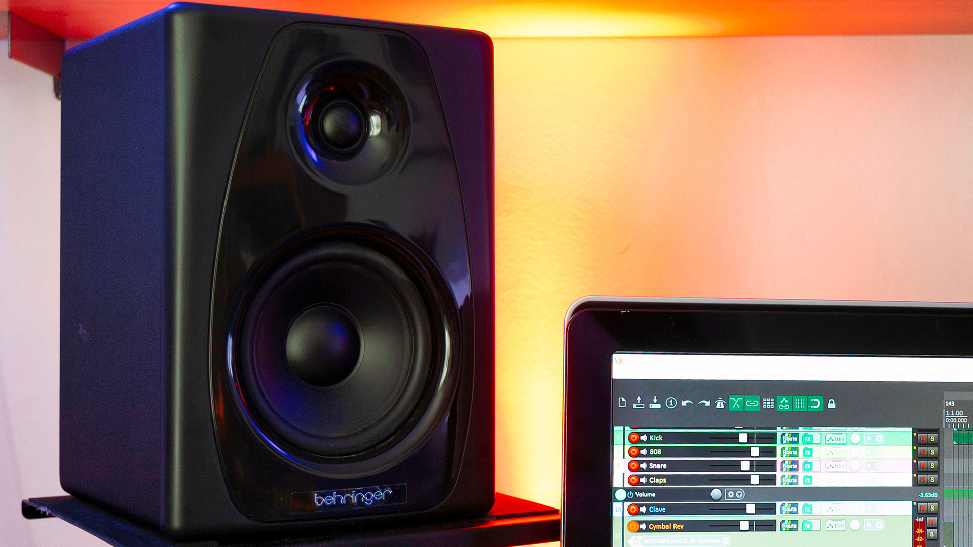 A photo of one Behringer Studio 50 USB speaker placed next to a computer screen.